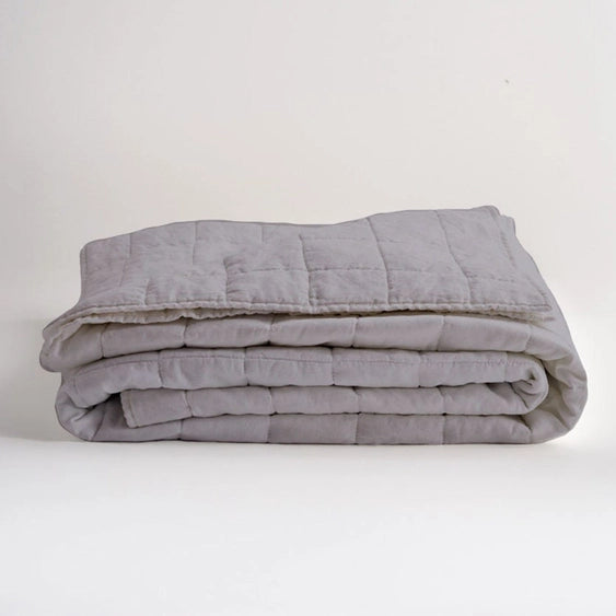 Folded gray weighted blanket on a white background