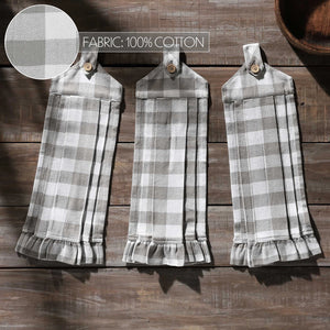 Three gray and white plaid cotton kitchen towels with ruffled hems and button tabs, displayed on a rustic wooden background. A circular fabric texture zoom-in is shown in the top left with text reading 'FABRIC: 100% COTTON'.