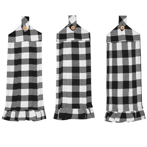 Three black and white buffalo plaid kitchen towel or apron-style hanging cloths with wooden buttons and ruffled hems, displayed side by side on a white background.