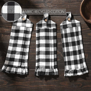 Three black and white checkered towels hanging on a wooden surface with a close-up of fabric texture above.
