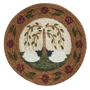 Round woven rug with sheep and tree design on a white background