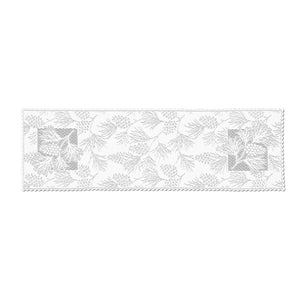 A rectangular white table runner with a delicate gray floral and pinecone pattern, featuring two square monogrammed patches on the sides and a braided edge.